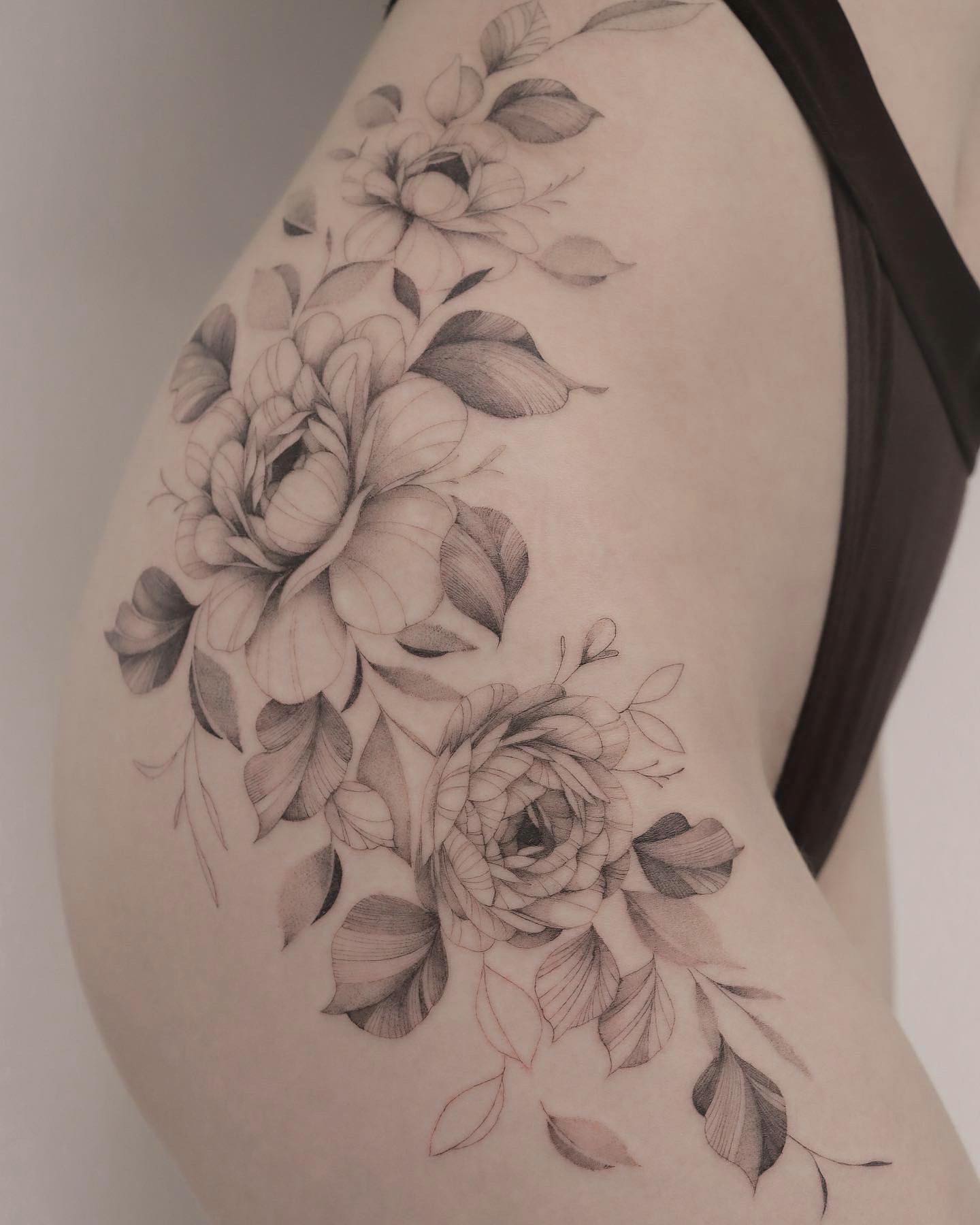 Tatuaje grande de cadera con flor.