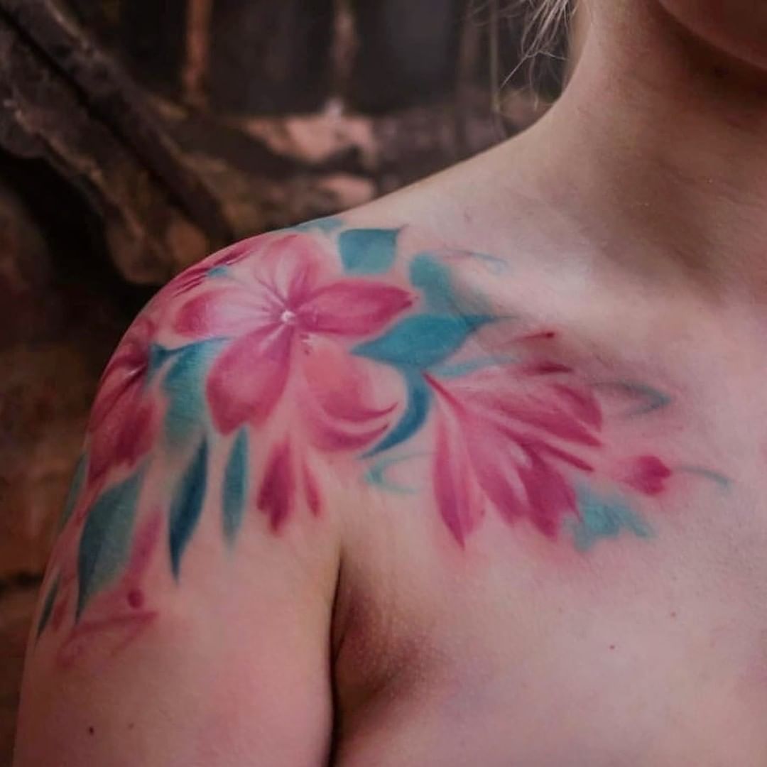 Tatuaje de flor de cerezo en la clavícula