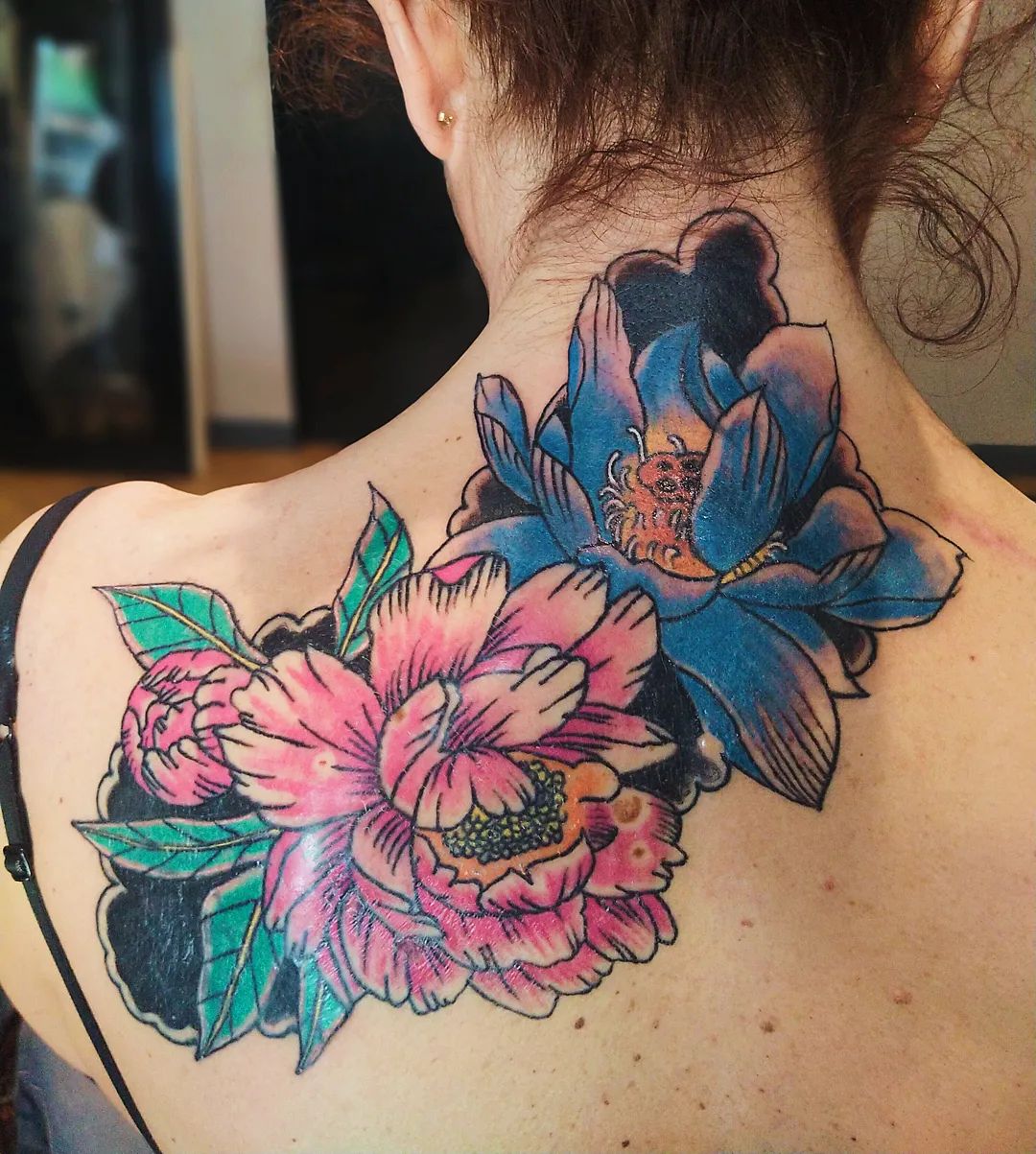 Idea de tatuaje de loto trasero colorido.
