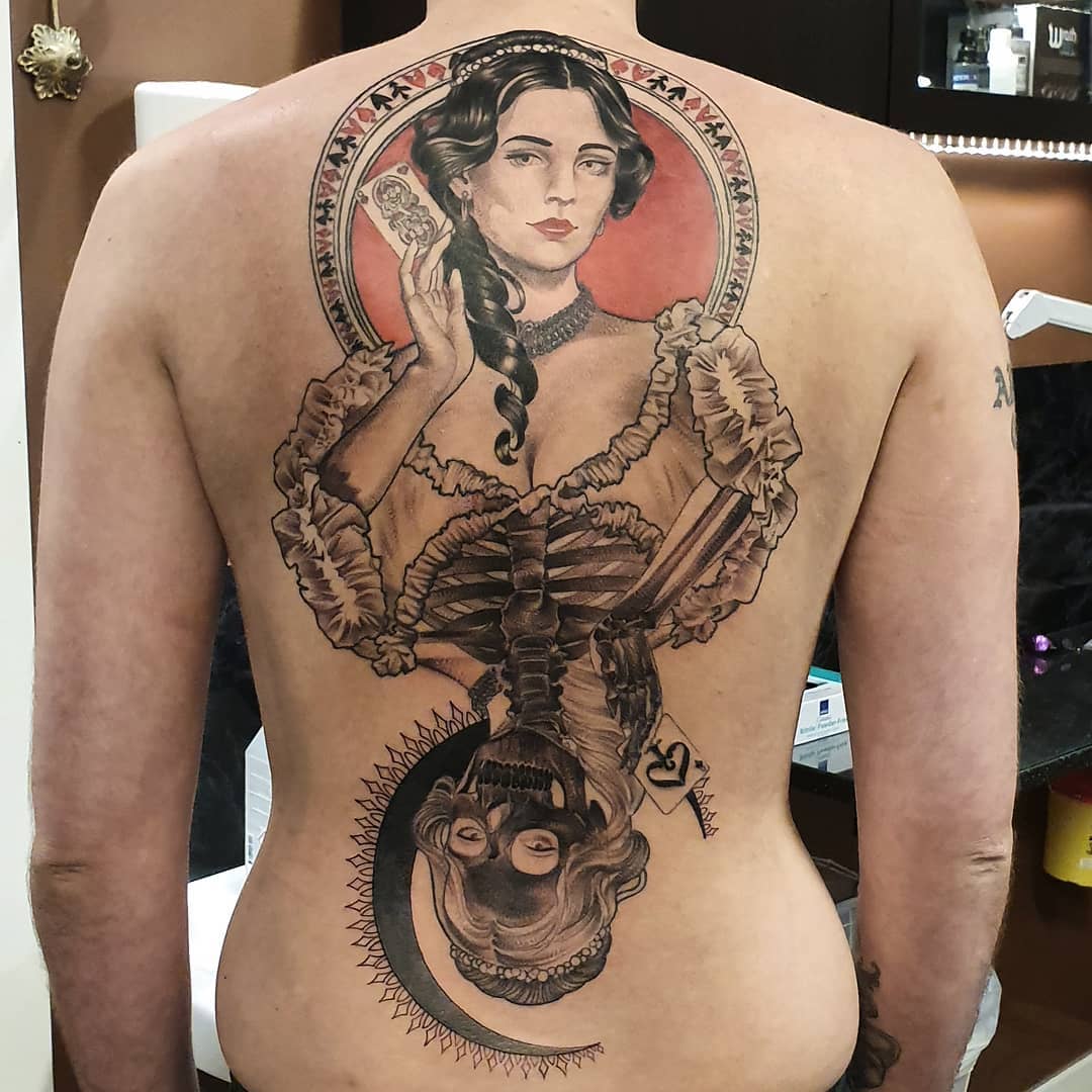 Detallado tatuaje de la Reina de Espadas en la espalda.