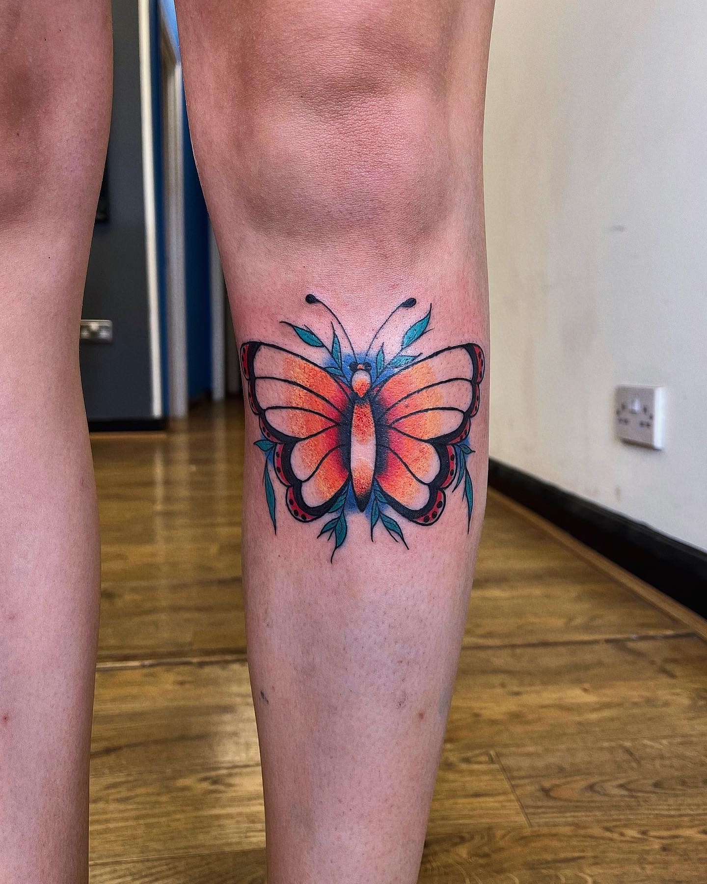 Tatuaje de mariposa fresco en la rodilla
