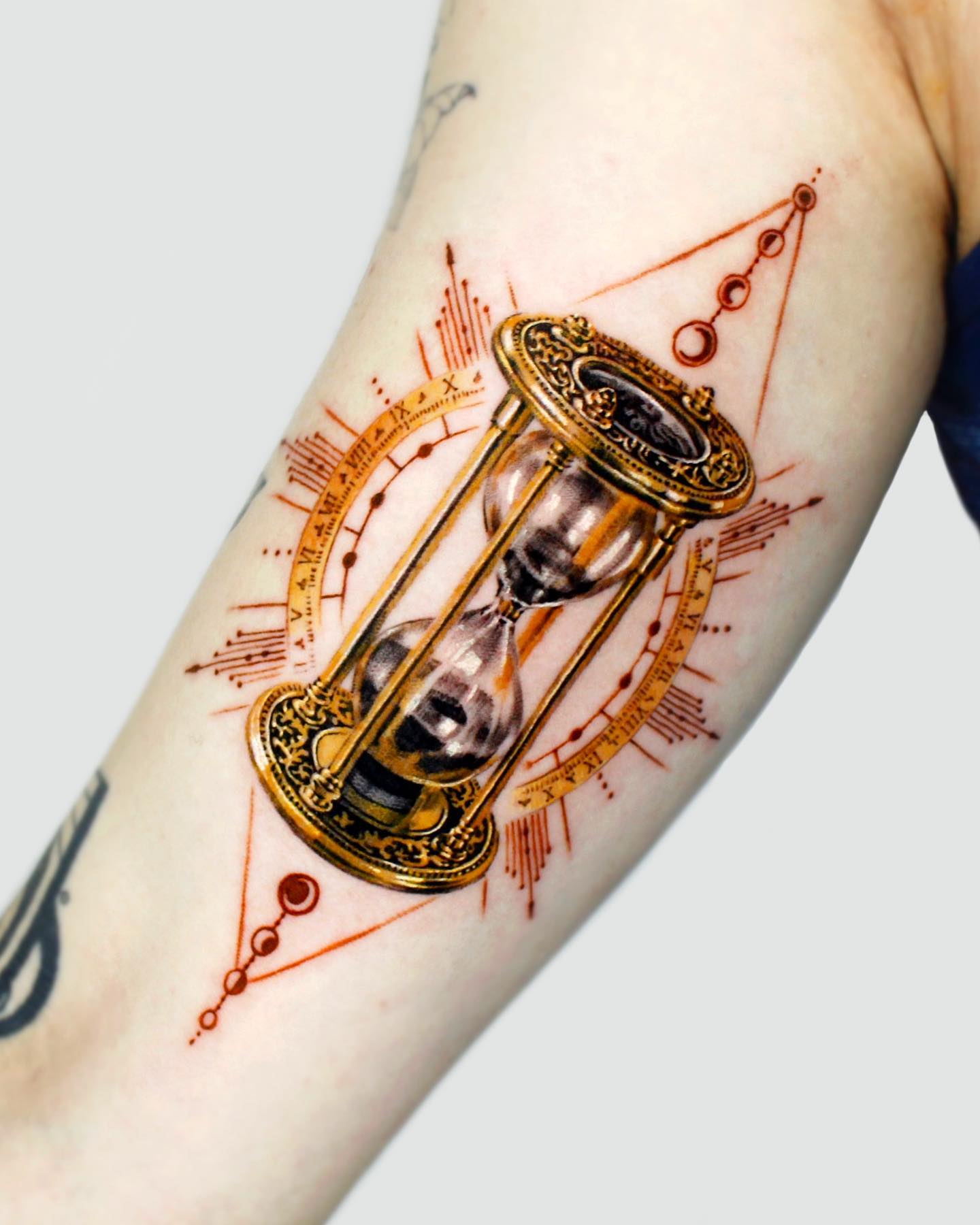 Tatuaje de reloj de arena dorado