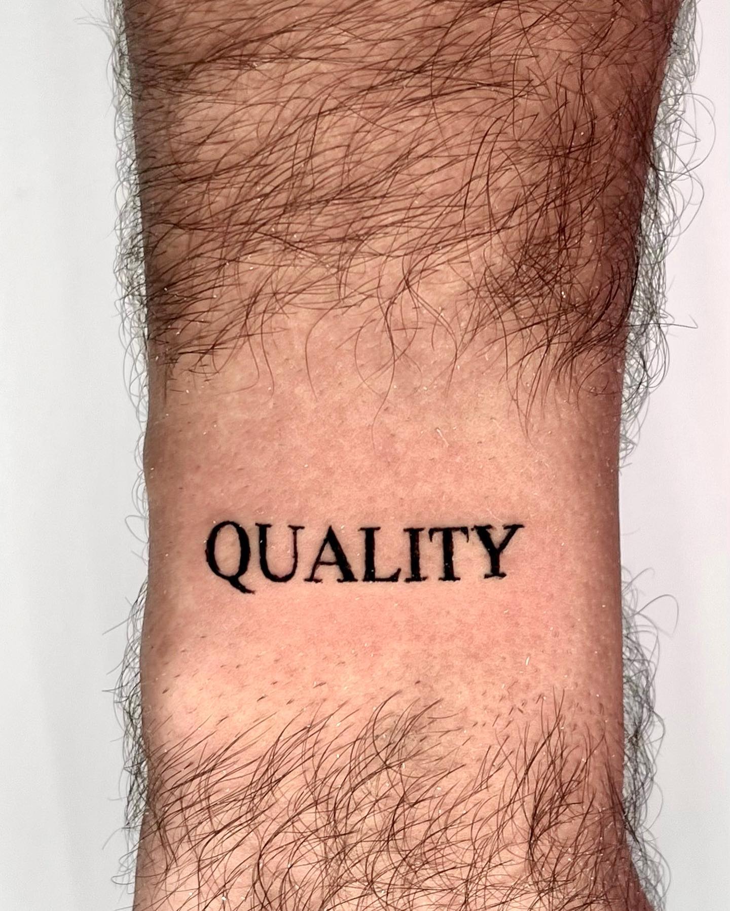 Tatuaje de una sola palabra de calidad.