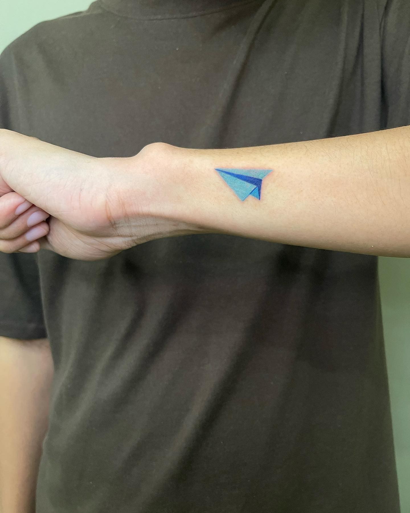 Tatuaje de avión de papel y símbolo de corazón